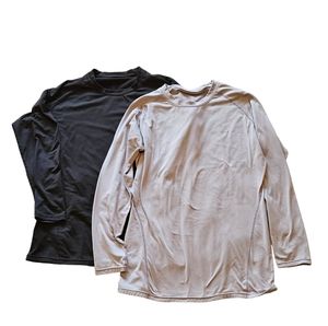 Set of Devops 2XL Men's compression long sleeved shirts, one black, one gray.